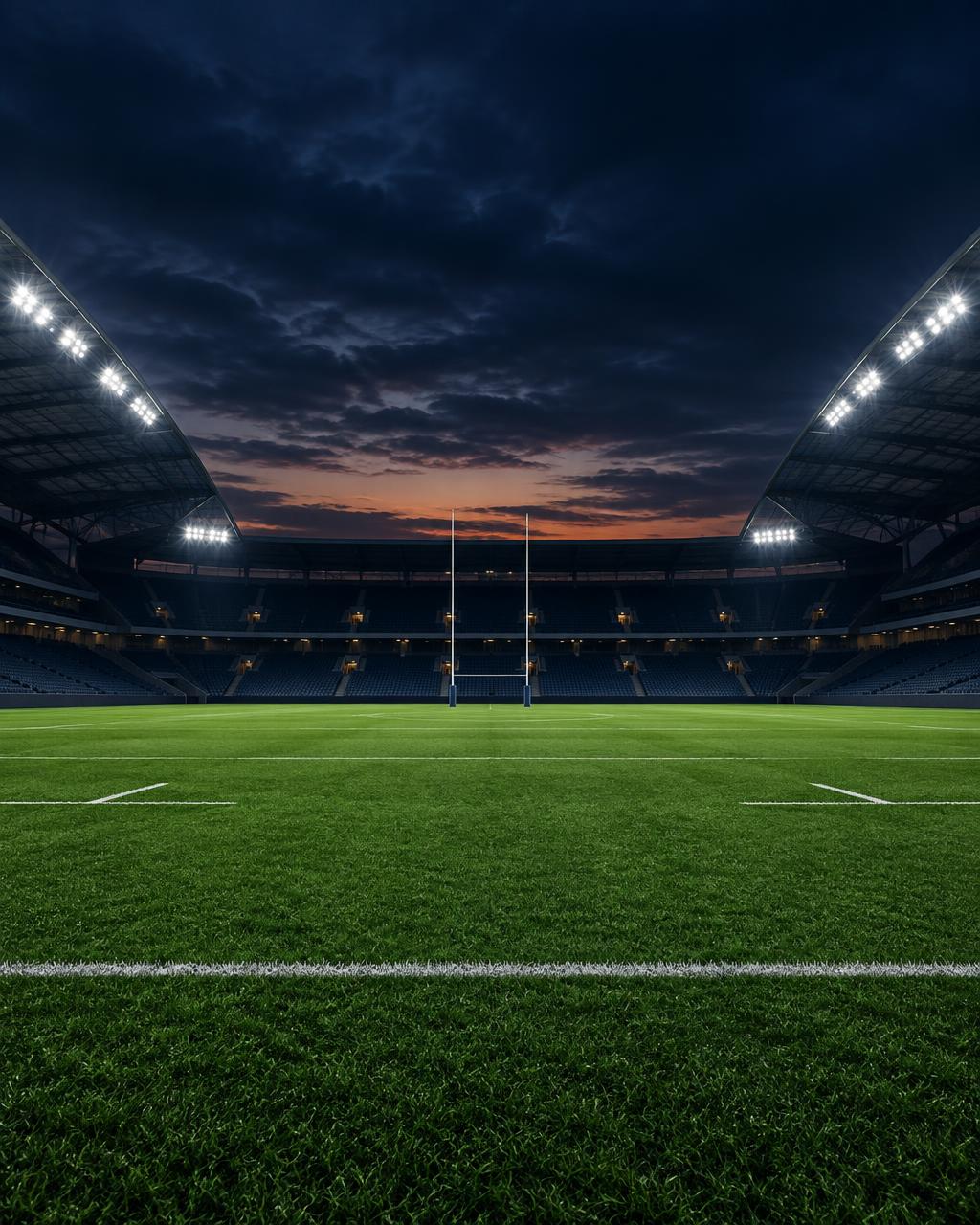 Empty rugby stadium at dusk with floodlights on
